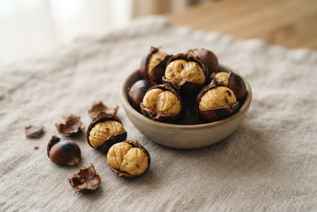 Roasted Chestnuts: peeled golden chestnut lobes, dark shells, on natural linen